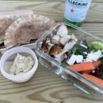 Greek chicken pita meal prep. Eating lunch outside with sparkling water.