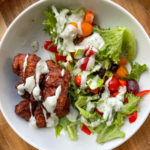 Mediterranean meatball bowls with salad greens, feta, and avocado dressing